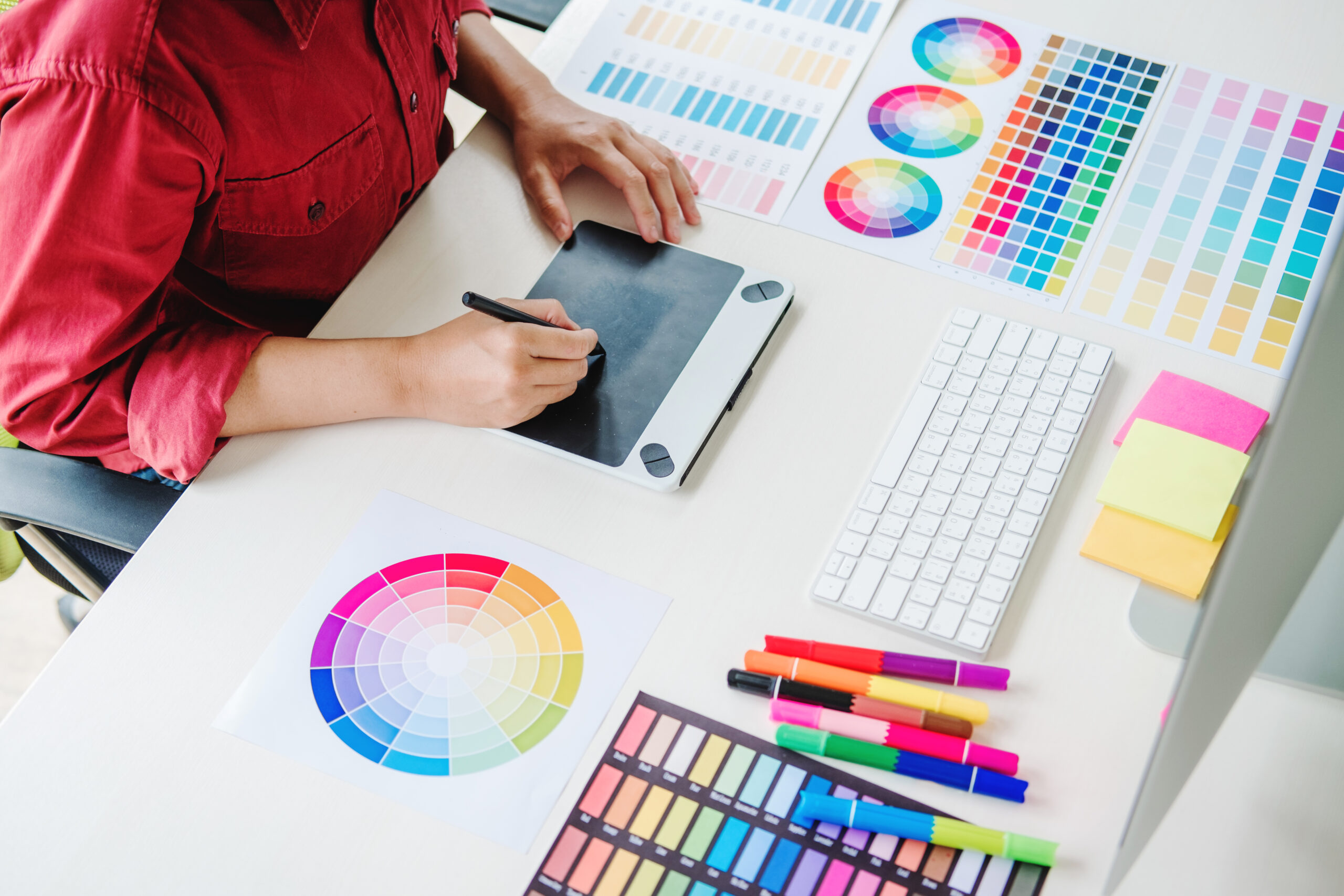 two graphic designer brainstorming meeting and drawing on graphi